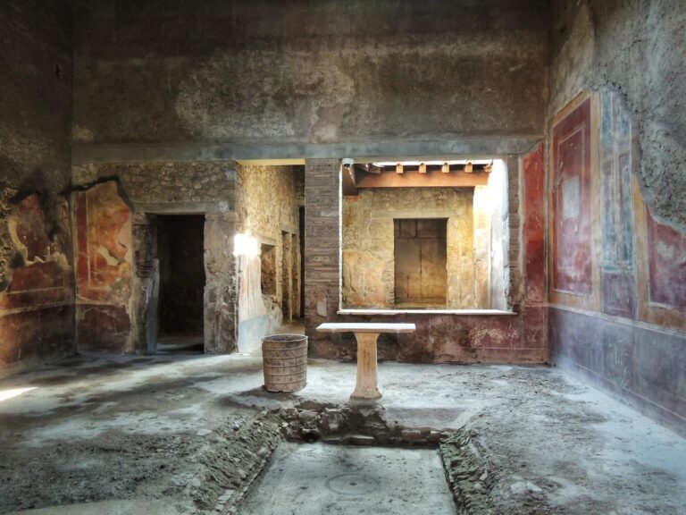 Atrium of the House of the Tragic Poet in Pompeii showing the impluvium pool, a marble table and frescoes in the fourth style