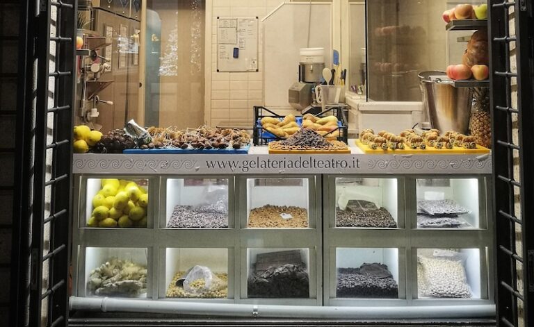 view of the window of gelateria del teatro with the ingredients in the window