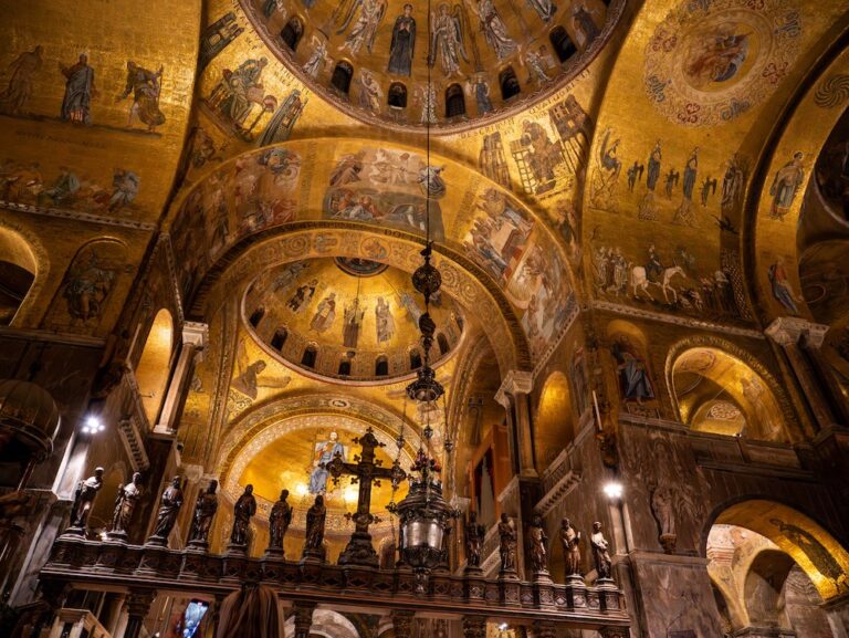 The glistening mosaics of St Marks at night shine in candelight